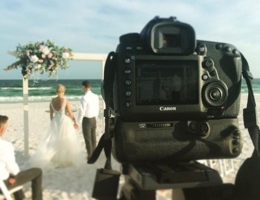 a video shot of a bride and groom getting married on the beach